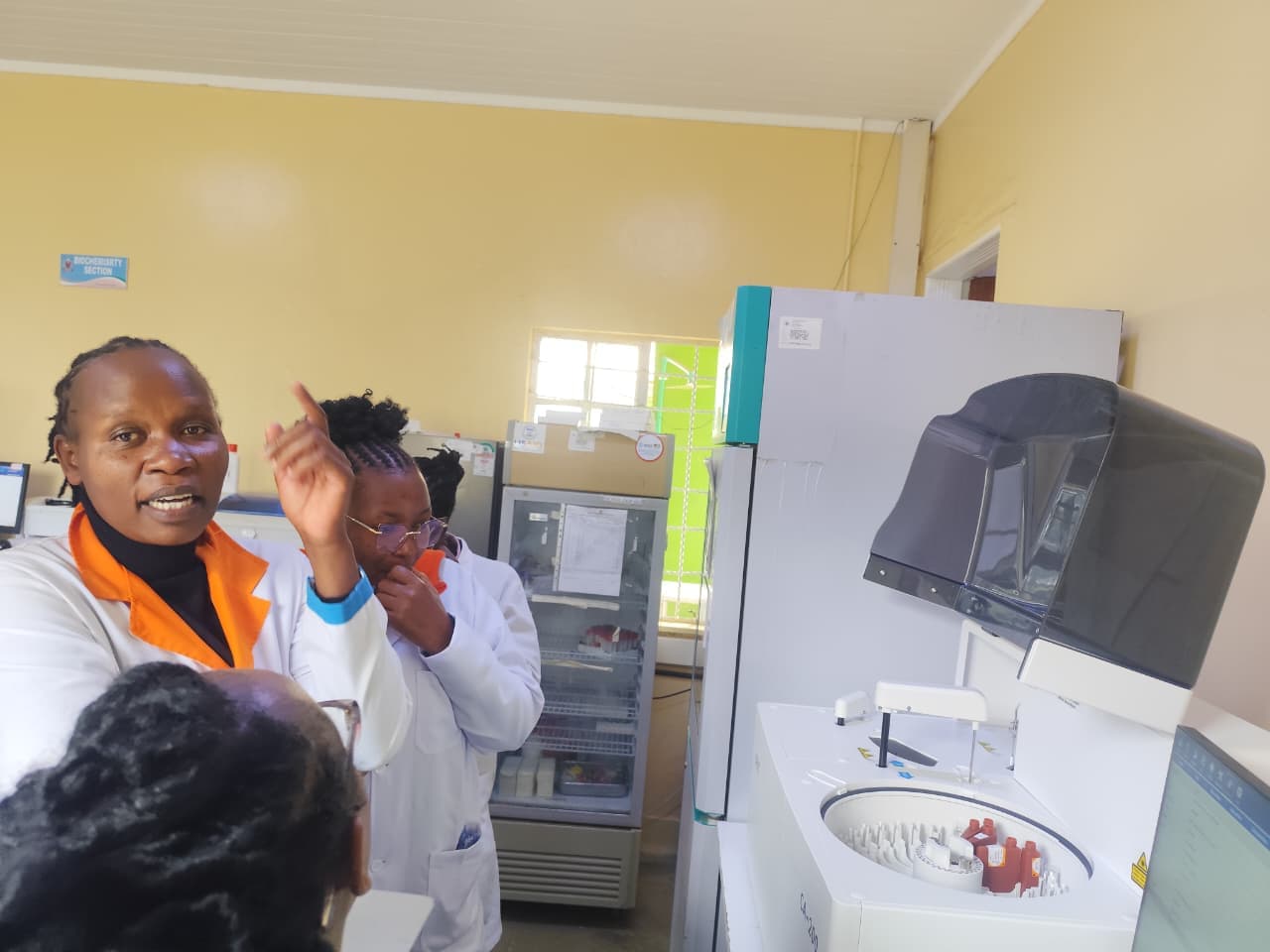 Clinical laboratory technologist training on biochemistry analyzer