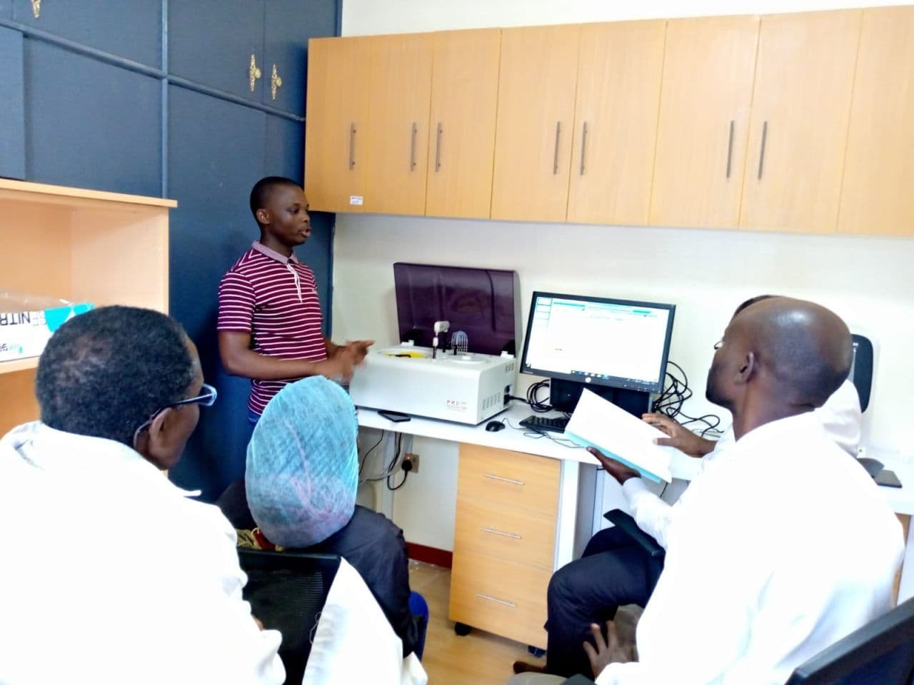 Biomedical engineer conducting medical equipment installation and functional checks in a Kenyan clinic