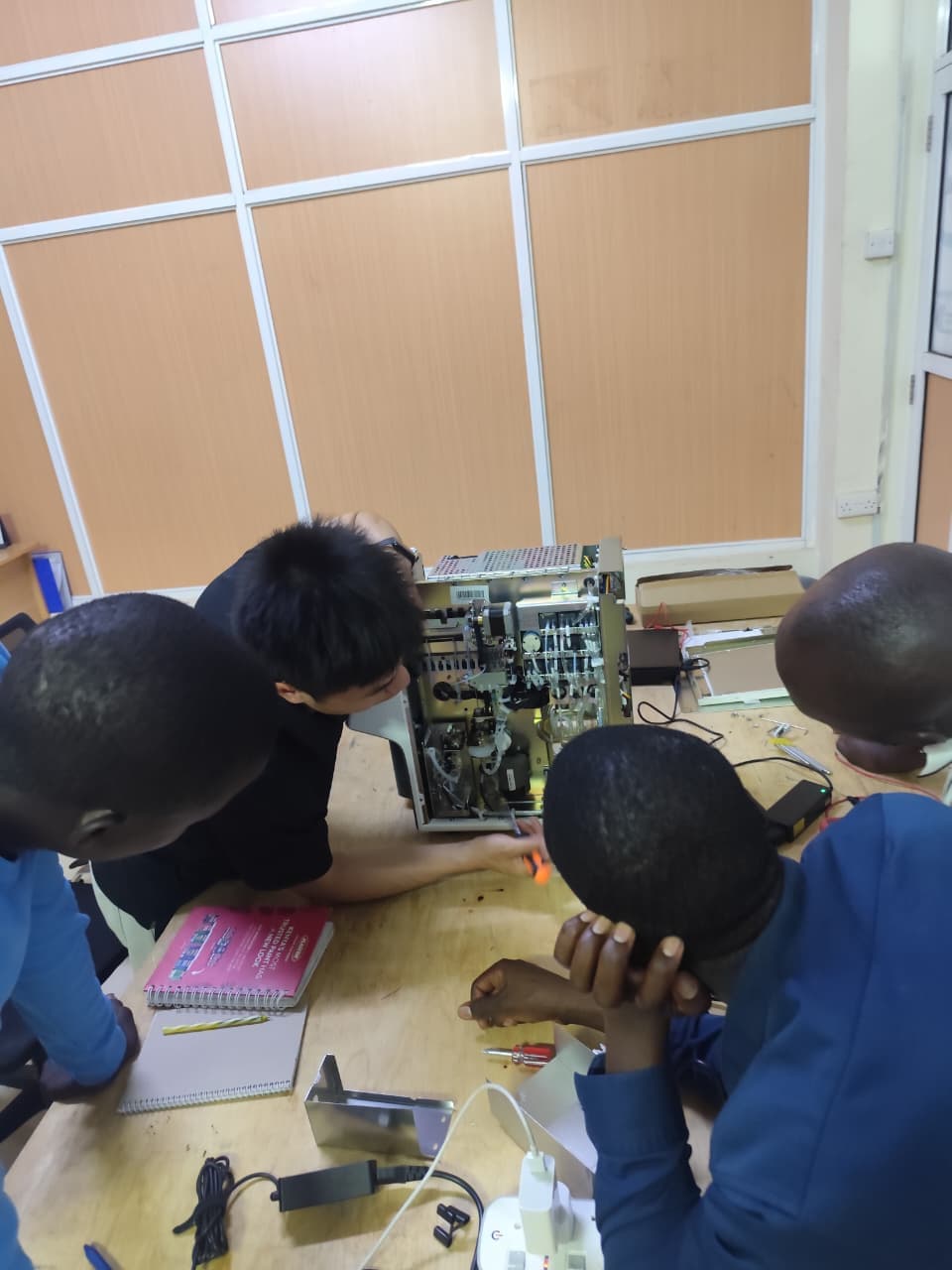 Biomedical technician performing fault diagnosis and circuit board repair on medical equipment